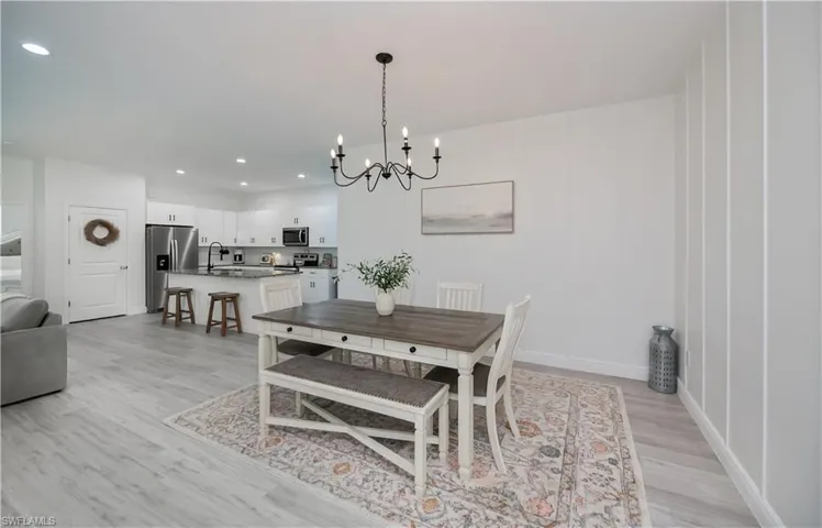 Dining space featuring light wood-style flooring and suspended lighting
