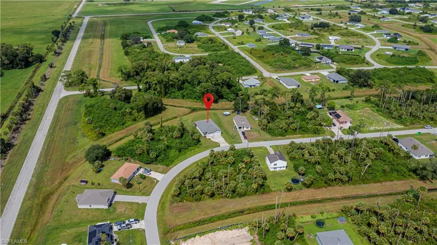 Aerial view of property's location featuring nearby suburban area