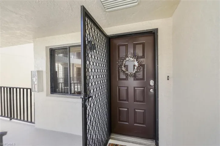 Entrance to property with stucco siding