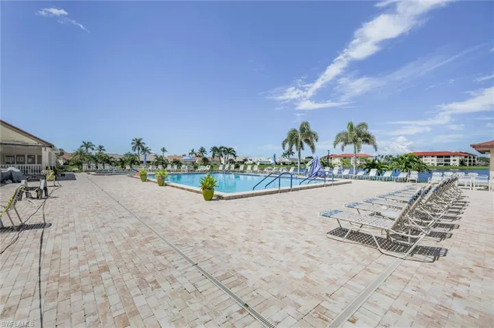 Community pool with a patio