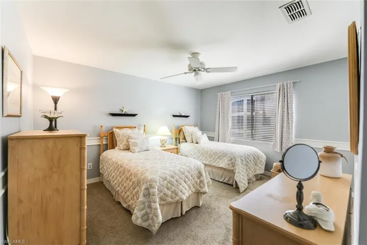 Carpeted bedroom with ceiling fan