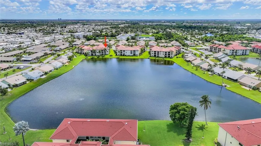 Aerial perspective of suburban area featuring a nearby body of water