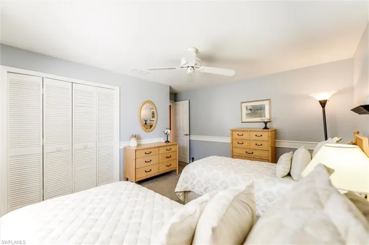 Bedroom featuring a closet, ceiling fan, and carpet floors