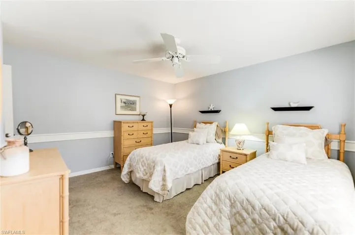 Bedroom featuring light colored carpet and a ceiling fan