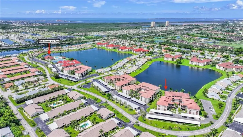 Aerial view of residential area featuring a large body of water