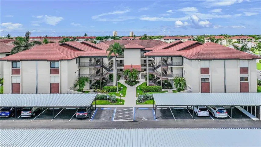 View of property with covered parking