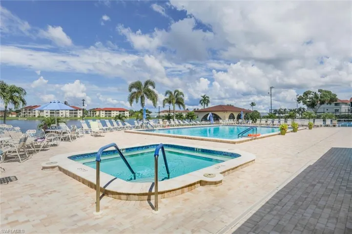 Community pool featuring a hot tub and a patio