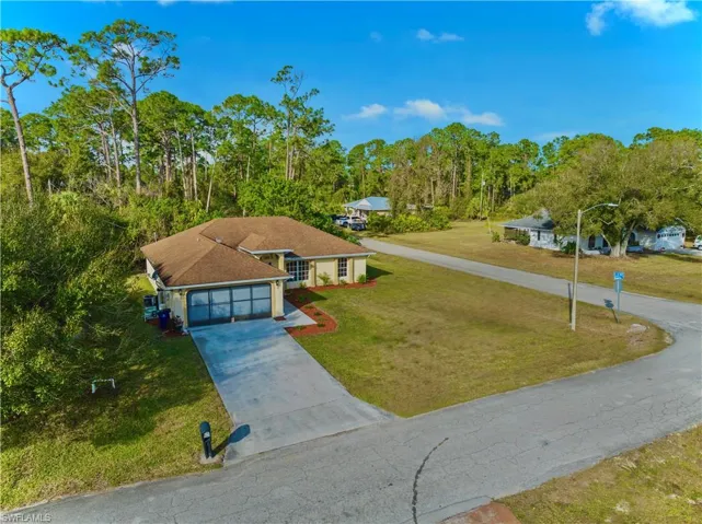 View of front facade featuring a front yard and a garage