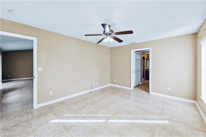 Spare room featuring tile patterned flooring and ceiling fan