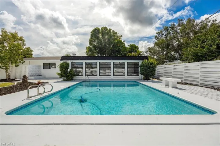 View of swimming pool featuring a patio area, fence, and a fenced in pool