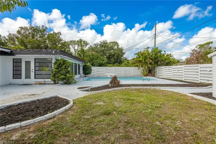 View of yard featuring a fenced backyard, a fenced in pool, and a patio area