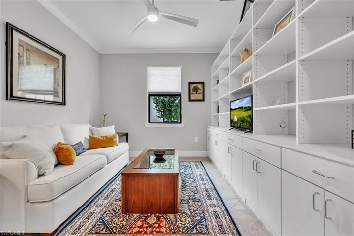 -featuring built in wall shelving and double doors