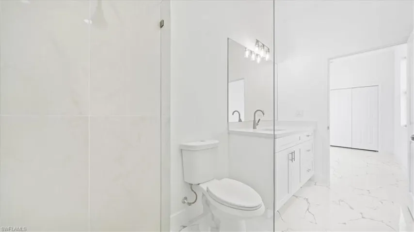 Full bathroom with vanity and light marble finish flooring