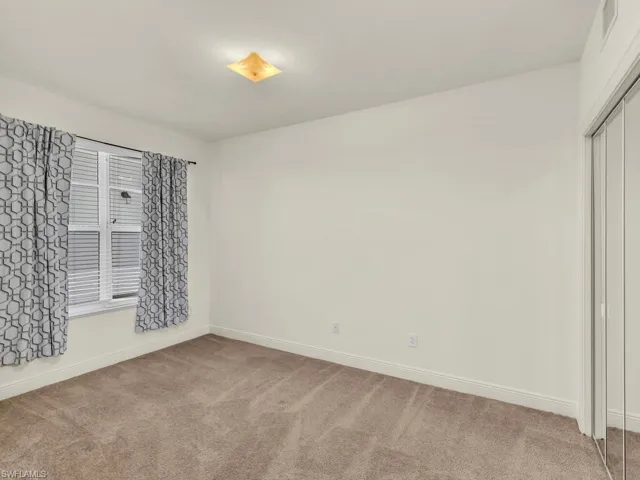 Unfurnished room featuring light colored carpet