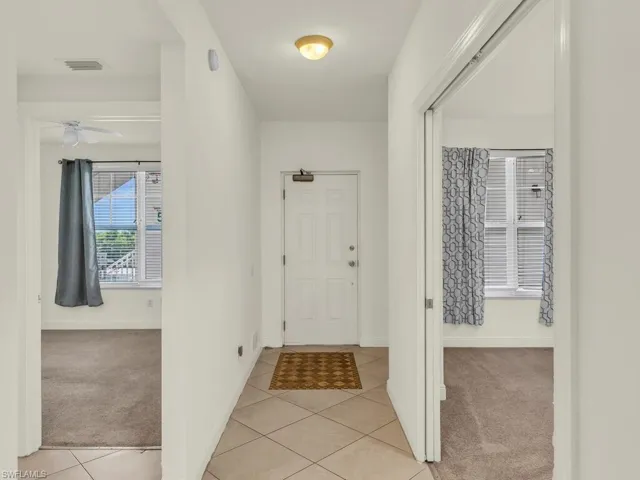Corridor featuring light tile patterned flooring