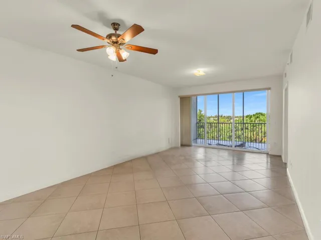 Spare room featuring ceiling fan and light tile patterned floors