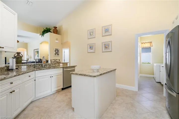 Kitchen featuring stainless appliances, granite countertops and island.