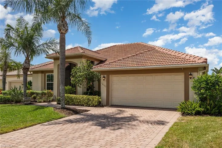 Mediterranean style house featuring 2 car garage, paver driveway and beautifully landscaped front yard.