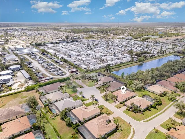 Aerial view of property and surrounding area with a nearby body of water and nearby suburban area