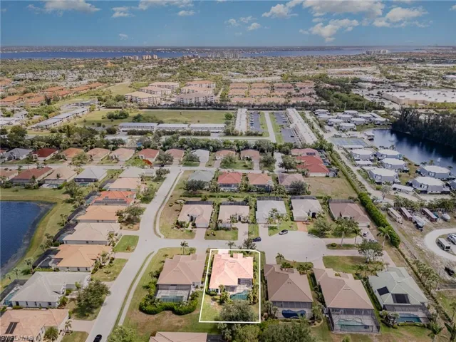 View of property location featuring a large body of water and nearby suburban area