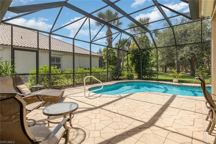 Swimming pool with pool cage and lots of room.