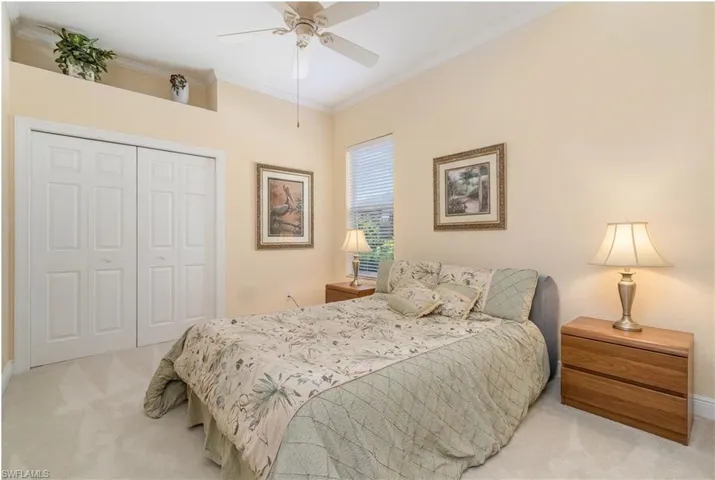 Virtually Edited. 4th Bedroom featuring a closet, ornamental molding, light colored carpet, and a ceiling fan