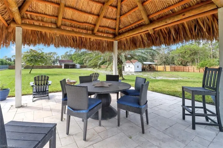 View of patio featuring a gazebo, outdoor dining space, and fence