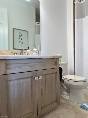 Full Guest bath with toilet, a shower with shower curtain, and vanity