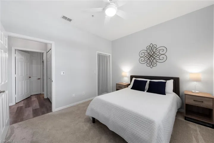 Carpeted bedroom featuring ceiling fan