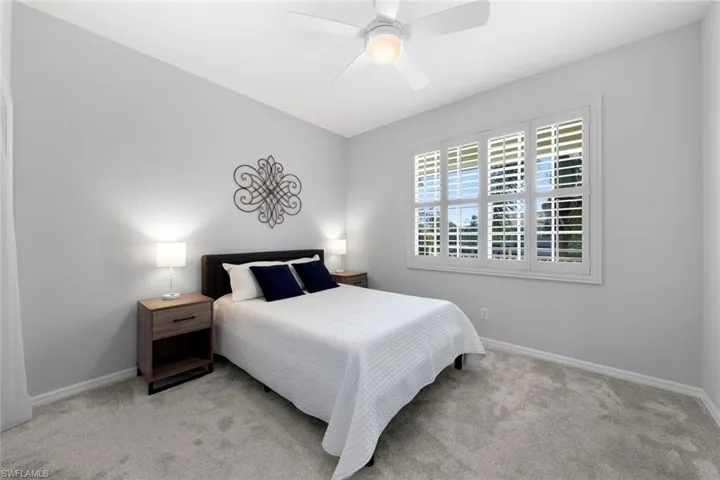 Carpeted bedroom with ceiling fan