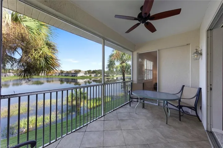 Sunroom featuring a water view and ceiling fan