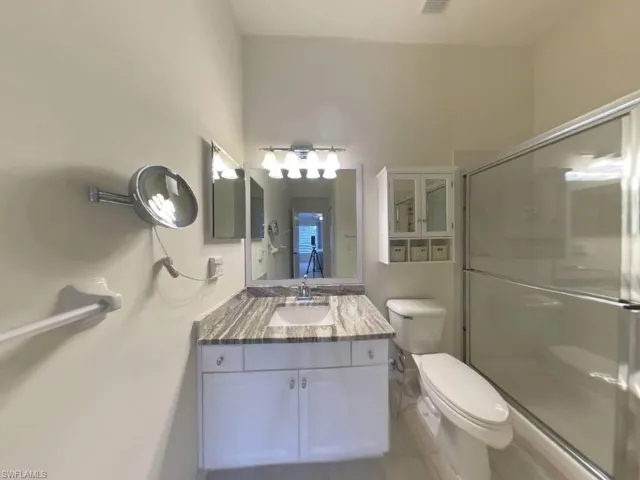 Primary bathroom has walk-in shower, medicine cabinet, granite countertop, large walk-in closet.