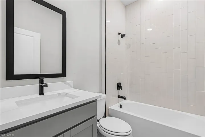 Full bathroom featuring shower / bath combination and vanity