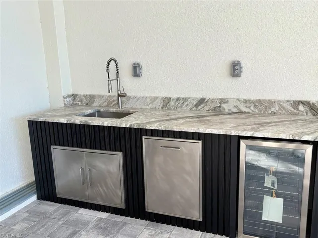 Bar with sink and beverage cooler