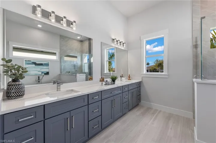 Bathroom featuring walk in shower, vanity, and hardwood / wood-style flooring