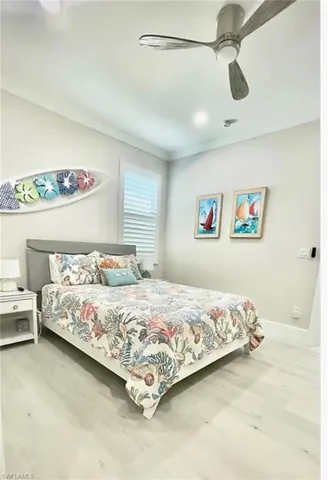 Bedroom with hardwood / wood-style floors and ceiling fan