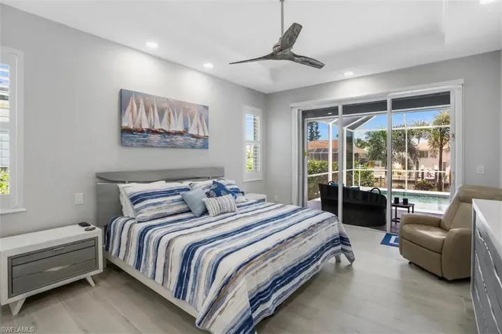 Bedroom featuring access to outside, light hardwood / wood-style flooring, and ceiling fan
