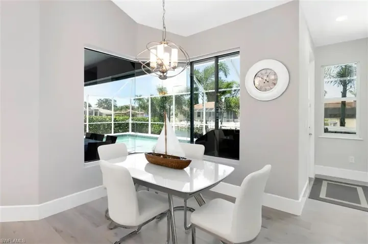 Dining space featuring light wood-type flooring and an inviting chandelier