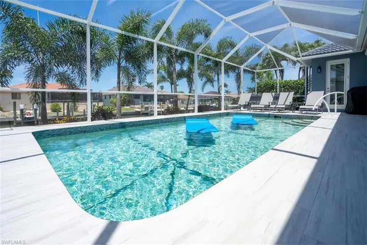 View of swimming pool with a lanai and a patio