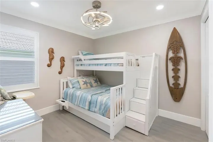Bedroom featuring an inviting chandelier and light hardwood / wood-style flooring