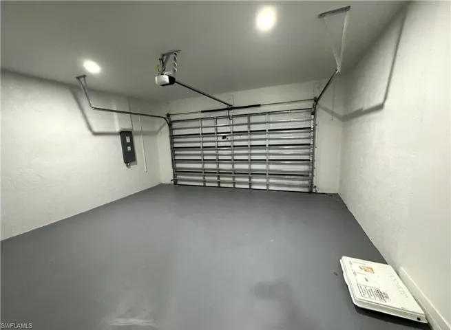 Garage with a textured wall and electric panel