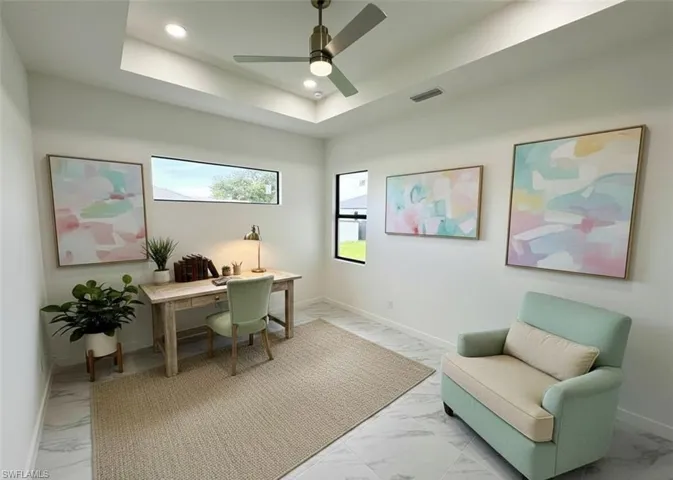 Office space with a ceiling fan, recessed lighting, light marble finish flooring, and a tray ceiling