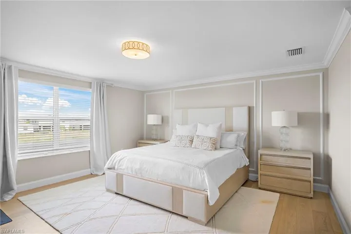 Bedroom with crown molding and light hardwood / wood-style floors