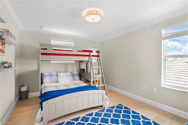 Bedroom featuring wood-type flooring and crown molding