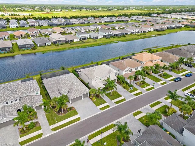 Birds eye view of property with a water view