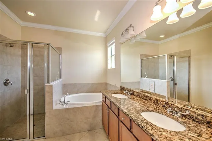 Master bathroom with shower and separate soaking tub; also dual sink area complemented by maple cabinetry and granite vanity tops!