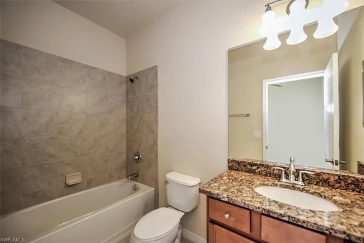 Main bathroom complete with tub and tiled shower walls, maple cabinets and granite vanity located in between 2 bedrooms as 'Jack and Jill' or den - bedroom set up!
