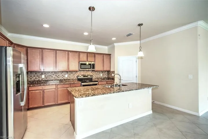 Another view of kitchen and island with pendant lighting!