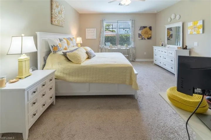 Bedroom featuring ceiling fan and carpet floors