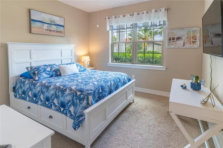 Bedroom featuring light carpet